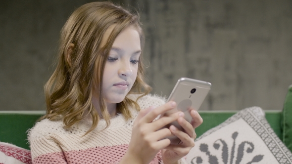 Teen Girl Chat With Friend By Smartphone at Home