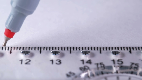 the Man Draws a Straight Line with a Ruler on a White Sheet