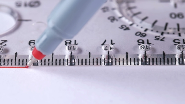 Man Draws a Straight Line with a Ruler on a White Sheet