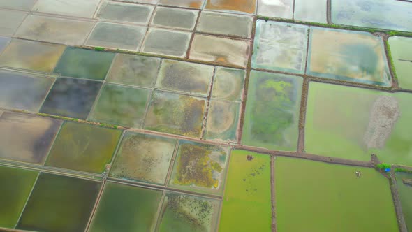 Aerial view flying over a beautiful colorful natural sea salt pond