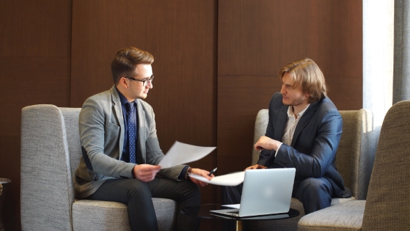 Two Young Businesspeople Having Discussion.