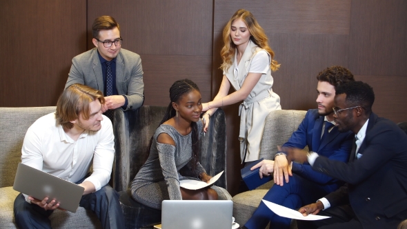 Manager Discussing Figures With His Multi-Ethnic Professional Team.