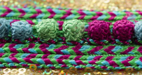 Knitted Color Pattern on Gold Shiny Fabric with Sequins Closeup