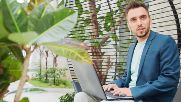 Young successful caucasian businessman works outdoor