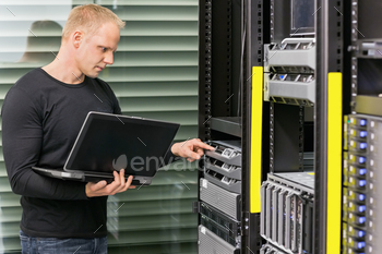 nd monitor blade servers in data rack. Shot in datacenter.