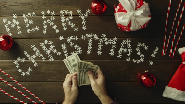 Adult Man Counts Cash Money By Christmas Decorated Table, Top Down Shot