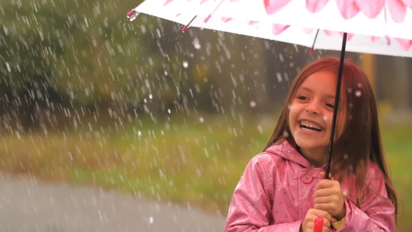 Little Girl Under Rain Having a Fun