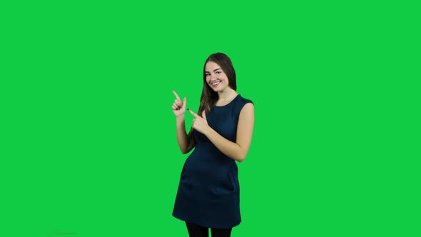 Happy excited girl pointing promoting in front of the green screen