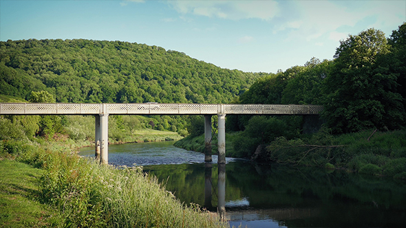 Car crosses Bridge Over River In Sunny Valley alt