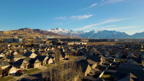 Low altitude flight over a suburban neighborhood towards Silicon Slope in Lehi, Utah