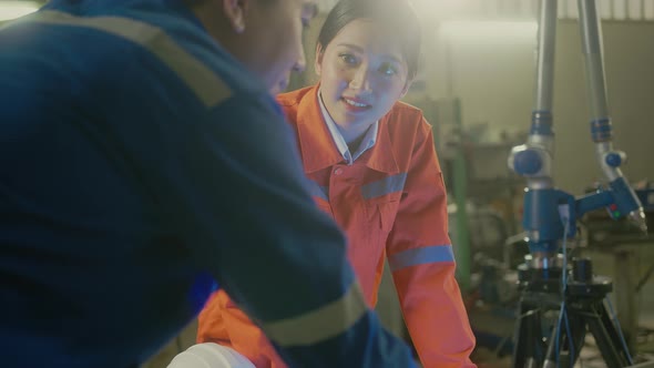 engineer cooperation Two asian male and female technician maintenance inspect relay robot system