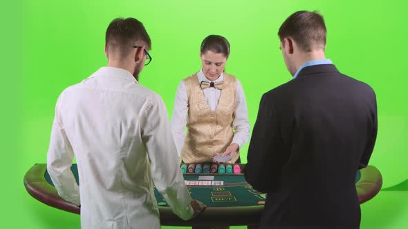 Players Play Poker in Casino at the Green Table. Green Screen. Slow Motion