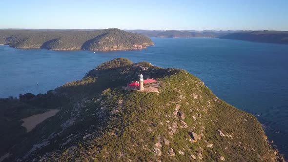 Ascending drone video footage of Barrenjoey Lighthouse with ocean view, Palm Beach, Australia.