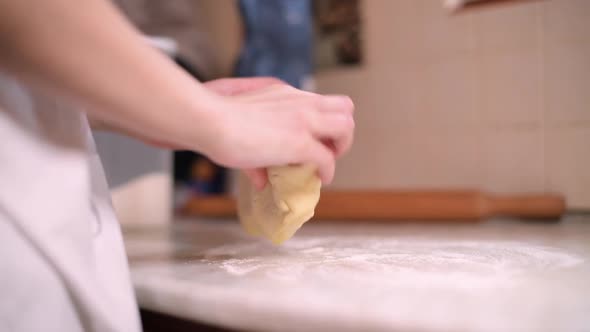 Girl kneads dough for baking, no face