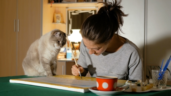The Artist Tries To Paint a Picture at Home, but Her Cat Prevents Her From Doing This
