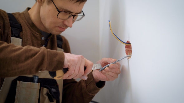 Wireman Is Stripping Wires for Installation Sockets, Cutting a Cable Sheath, Using Stationery Knife