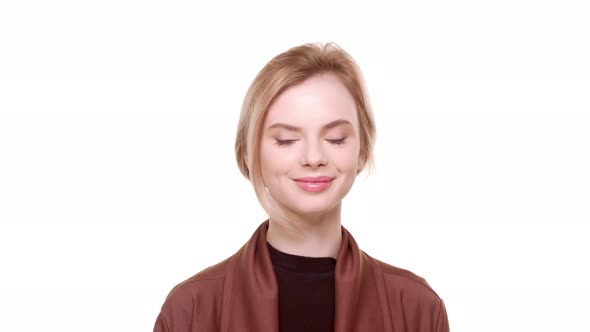 Young Teenager Beautiful Girl Standing on White Background and Smiling at Camera