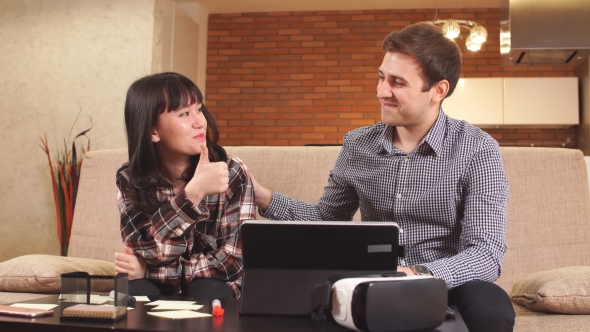 Young Couple at Home Uses Laptop for Online Shopping