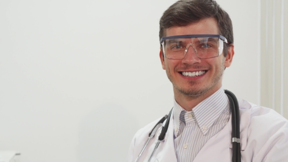 A Smiling Doctor Puts on Special Transparent Laboratory Glasses