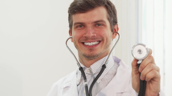 Cute Doctor Is Pointing at Camera His Stethoscope
