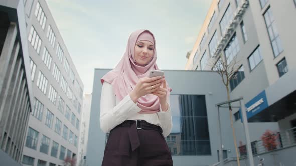 Low Angle View of Beautiful Muslim Woman Standing Near Modern Office Building