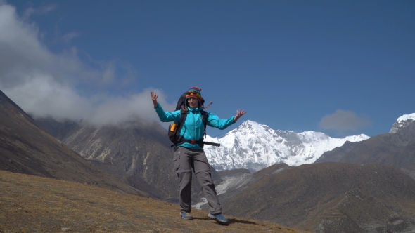 The Girl Dances on a Background of Mountains