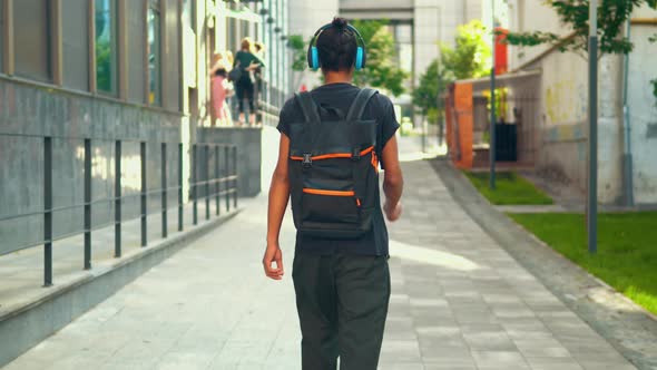 Rear Man Go with Backpack in Urban City