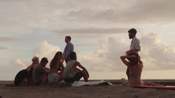 Group of Friends Waiting for Sunset on Beach in Bali