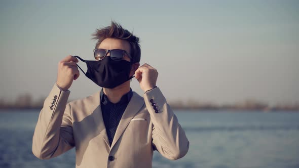 Man Wearing Face Mask On Quarantine Prevention Infection COVID-19 Virus. Man In Protective Mask.