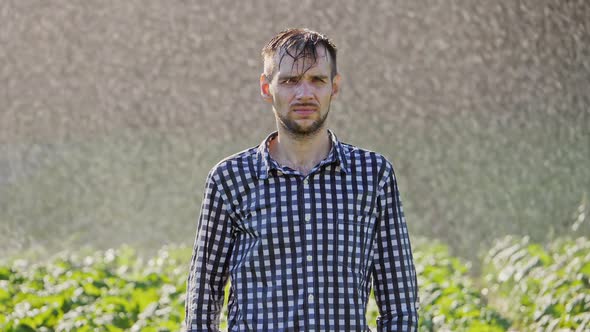 Portrait of Sad Man Standing Under the Rain. Super Slow Motion