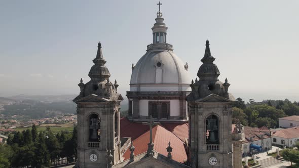 Close up pan shot capturing the clock bell towers and dome monumental sanctuary of sameiro.