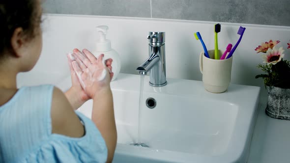 A Child Washes Hands with Soap Little Girl Hands Washing to Prevention Diffusion of Virus and