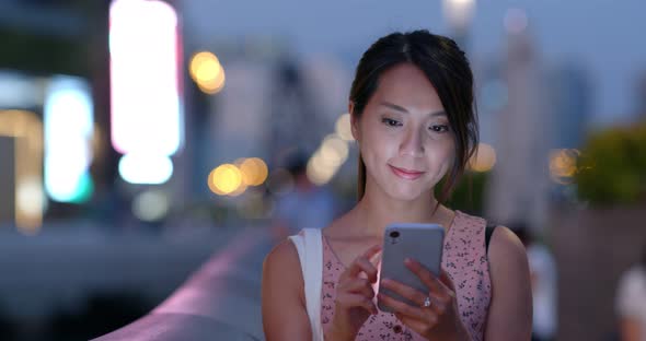 Woman use mobile phone at sunset time