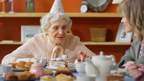 Grandmother Speaking with Family on Birthday Dinner