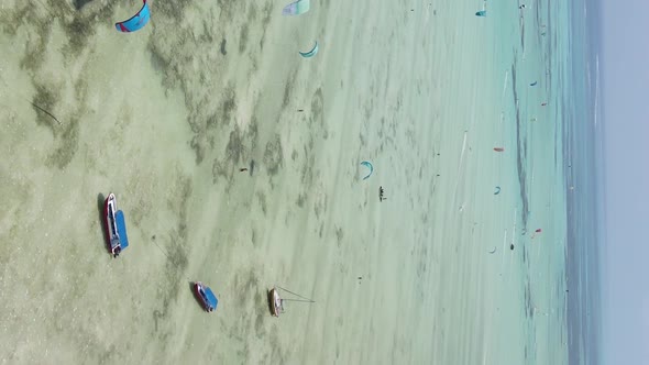 Vertical Video Kitesurfing Near the Shore of Zanzibar Tanzania Aerial View