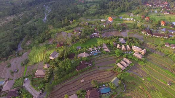 Aerial view of small straw bungalow neighborhood, Bali island, Indonesia.