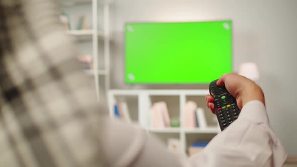 Middle Eastern Man Watching Tv with Chroma Key Closeup alt