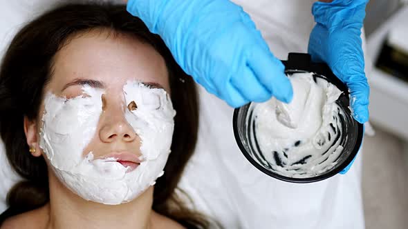 Doctor Cosmetologist or Dermatologist Making Face Mask in Cosmetology Salon