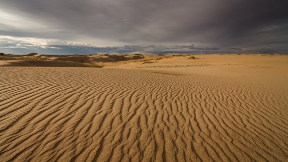 Clouds in the Desert Above the Sand Dunes