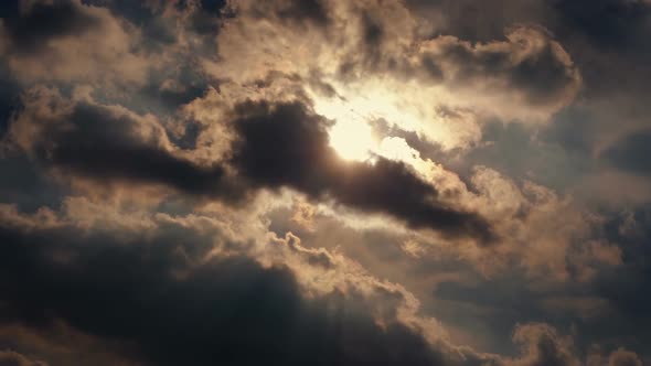 Dramatic Clouds Moving Past Sun