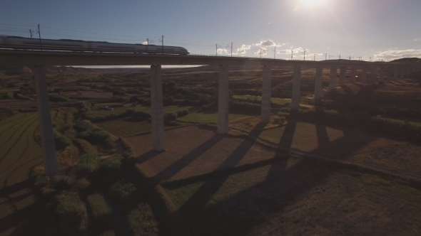 Backlit of Train Over Bridge at Sunset