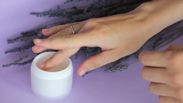 Lavender Body Cream and Lavender Bouquet on Violet Background