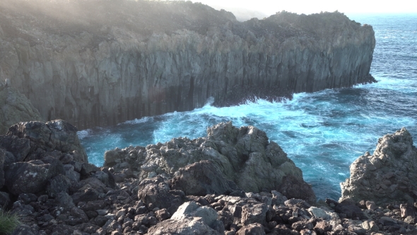 Deep Cliff Over Atlantic Ocean at Sunset with Ray Lights