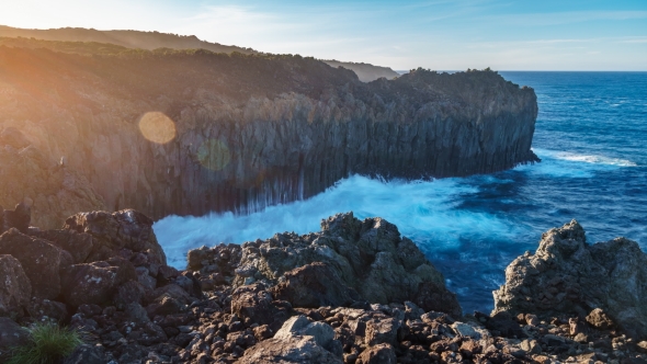 Deep Cliff Over Atlantic Ocean at Sunset with Ray Lights