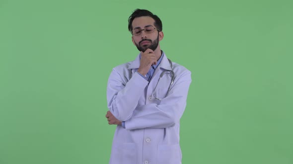 Happy Young Bearded Persian Man Doctor Thinking