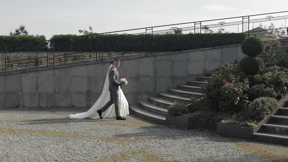 Lovely Newlyweds Caucasian Bride Groom Walking in Park Holding Hands Wedding Couple Family