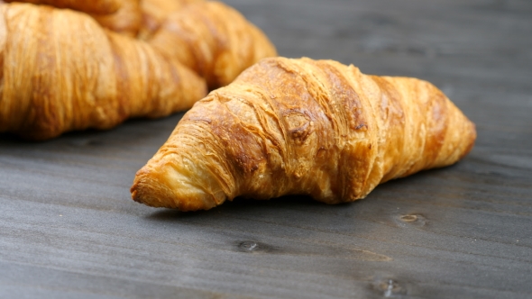 Delicious Croissants on a Piece of Old Wood