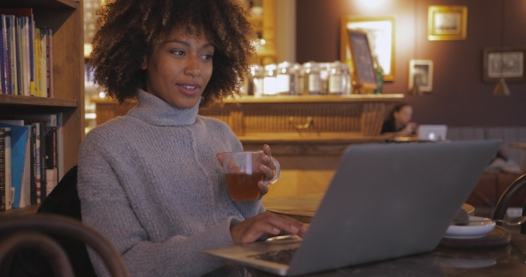Woman with Tea at Laptop
