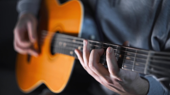 Guitar Player Plays Scales and Gamms on the Acoustic Western Guitar