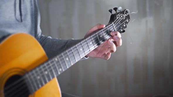 Guitarist Plays on the Acoustic Western Guitar with Steel Strings Spanish Random Chords